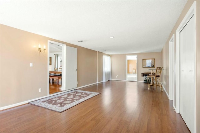 unfurnished room with dark wood-type flooring and a textured ceiling