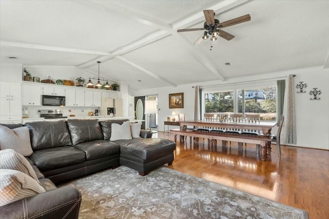 living room featuring vaulted ceiling with beams, hardwood / wood-style flooring, a textured ceiling, and ceiling fan