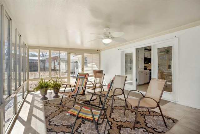 sunroom featuring ceiling fan