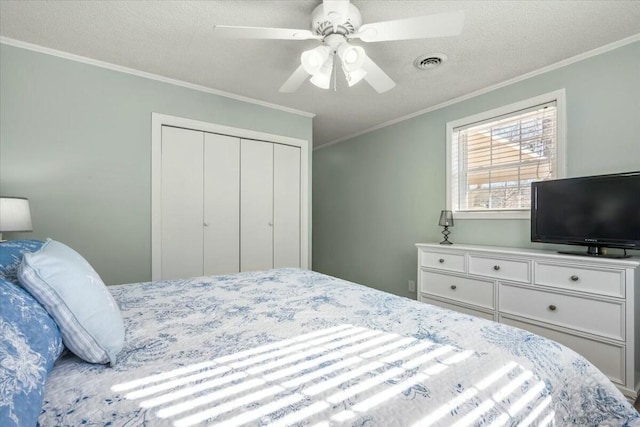 bedroom featuring crown molding, a closet, and a textured ceiling