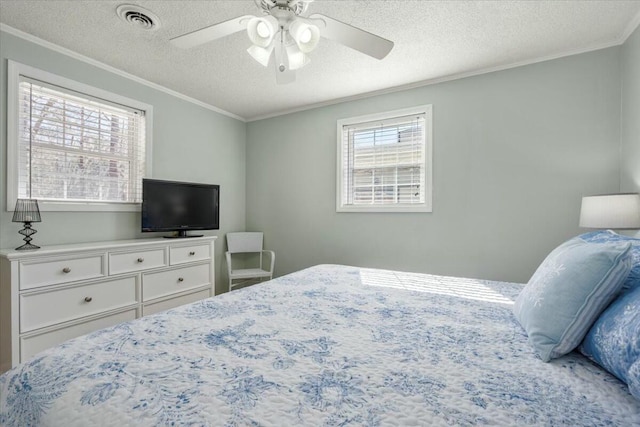 bedroom featuring crown molding, ceiling fan, and a textured ceiling