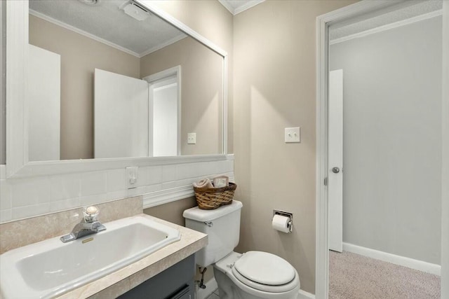 bathroom featuring ornamental molding, vanity, and toilet