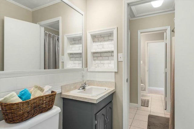 bathroom with ornamental molding, toilet, tile patterned flooring, and vanity