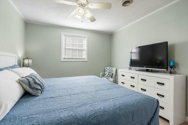 bedroom featuring ceiling fan, crown molding, and a textured ceiling