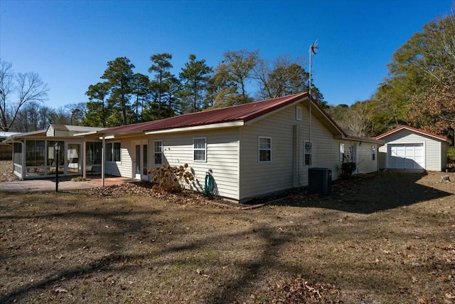 view of property exterior featuring a shed, central AC unit, a lawn, and a patio