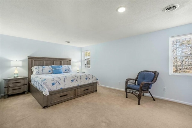 carpeted bedroom featuring a textured ceiling