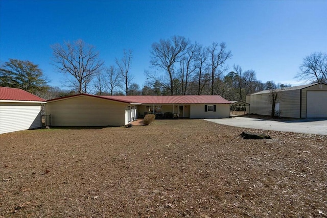 rear view of house featuring a garage and an outdoor structure