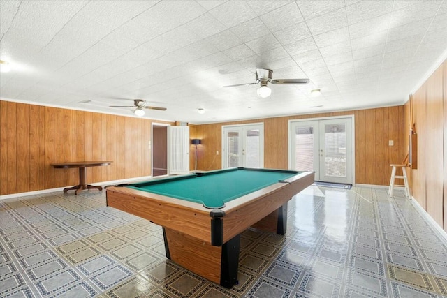 game room with french doors, pool table, ceiling fan, and wood walls