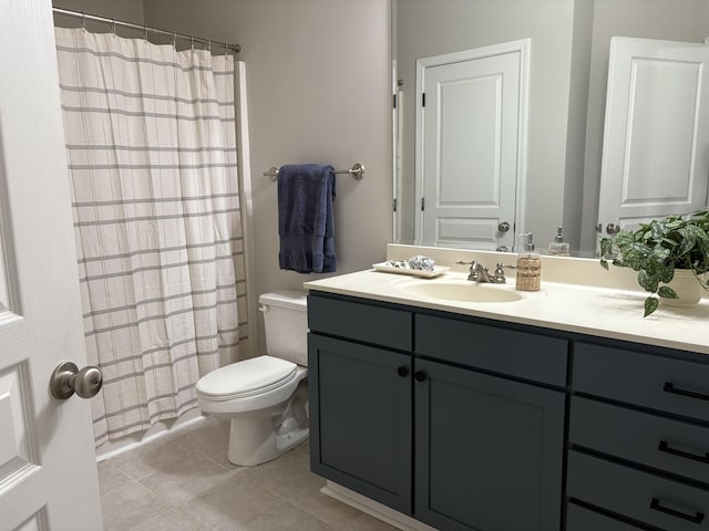 bathroom featuring tile patterned flooring, vanity, and toilet