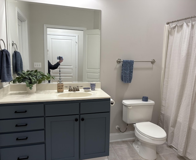 bathroom featuring vanity, tile patterned floors, and toilet