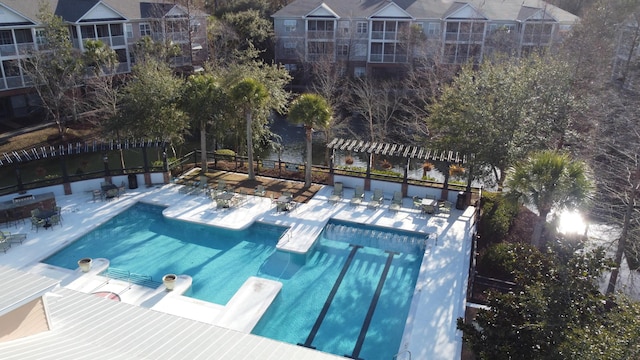 view of pool featuring a pergola and a diving board