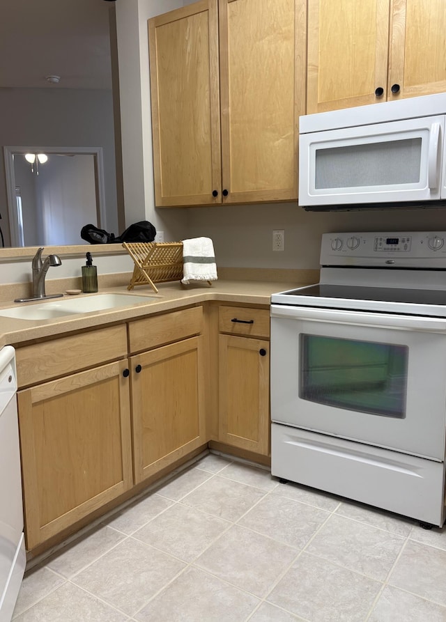 kitchen featuring light tile patterned flooring, sink, and white appliances