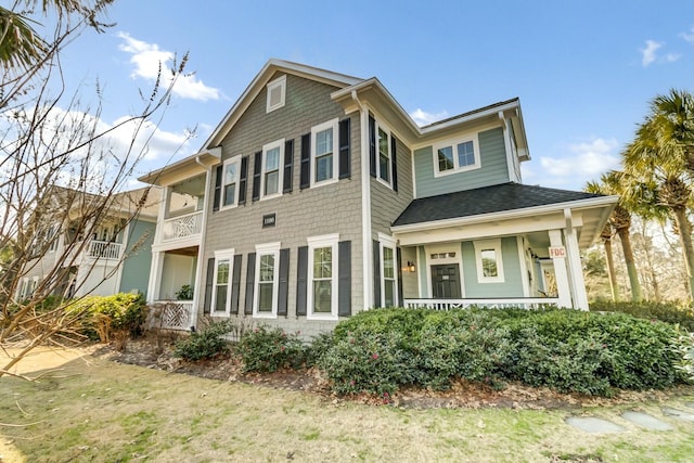 view of front of property with a shingled roof and covered porch