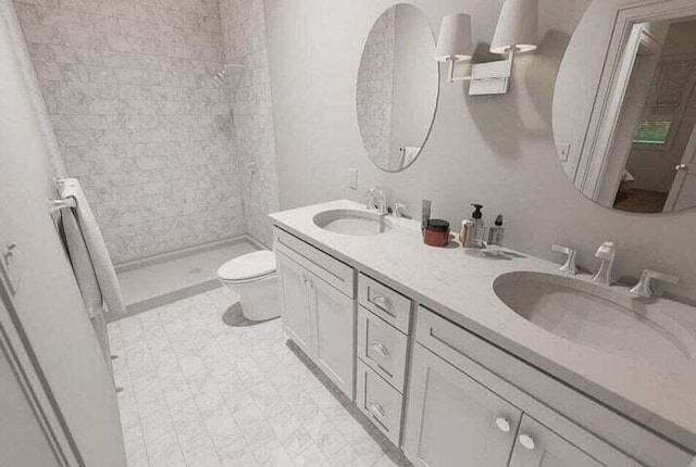 bathroom with tiled shower, vanity, and toilet