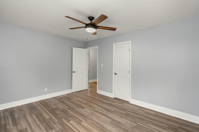 unfurnished bedroom featuring wood-type flooring and ceiling fan