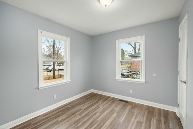 empty room featuring hardwood / wood-style flooring