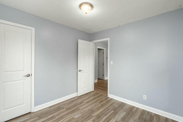 unfurnished bedroom with light wood-type flooring