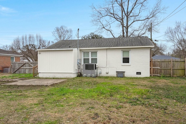 back of house featuring central air condition unit, a yard, and a patio