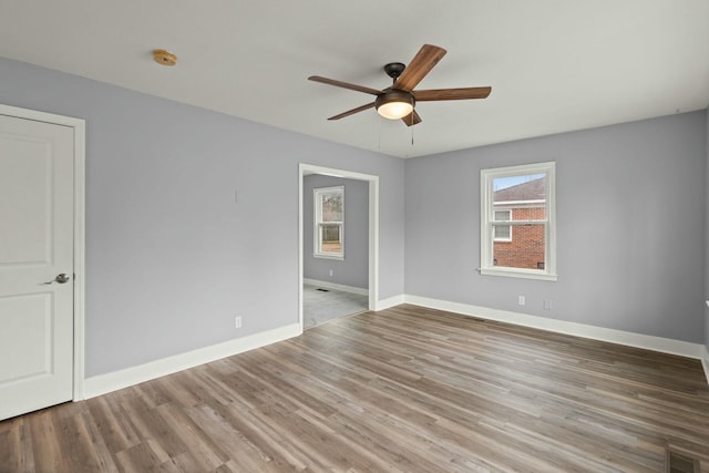 empty room featuring wood-type flooring and ceiling fan