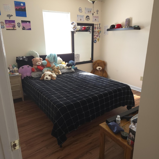 bedroom with hardwood / wood-style floors