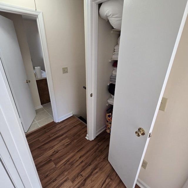 hallway with dark hardwood / wood-style floors