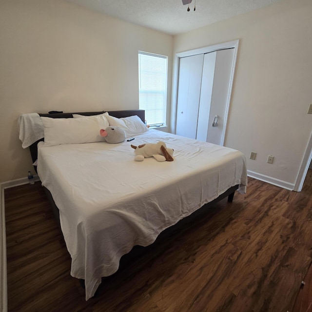 bedroom with dark hardwood / wood-style flooring, a closet, and a textured ceiling