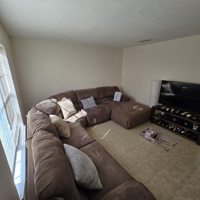 tiled living room with a textured ceiling