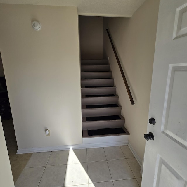 stairway featuring tile patterned floors