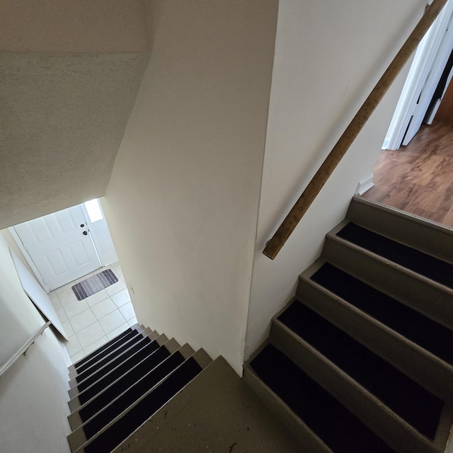 stairway with tile patterned flooring