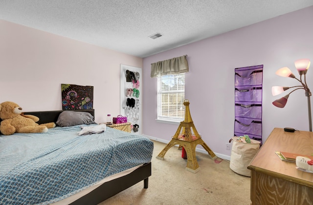 carpeted bedroom featuring visible vents, baseboards, and a textured ceiling