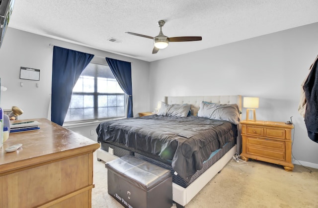 bedroom with visible vents, light colored carpet, a textured ceiling, and a ceiling fan