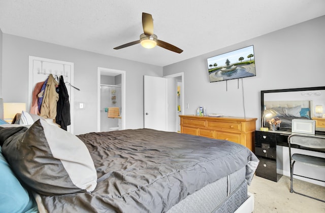 bedroom featuring light carpet, a textured ceiling, and ceiling fan