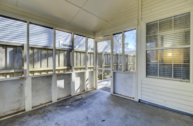 unfurnished sunroom with lofted ceiling