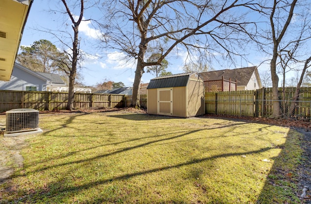 view of yard with cooling unit, a fenced backyard, an outbuilding, and a storage shed