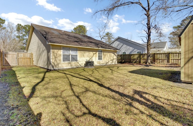 back of property with a yard and a fenced backyard