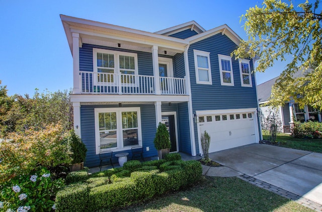 3306 Hartwell St, Johns Island, SC 29455 - view of front of house featuring a balcony, a garage, driveway, and a porch