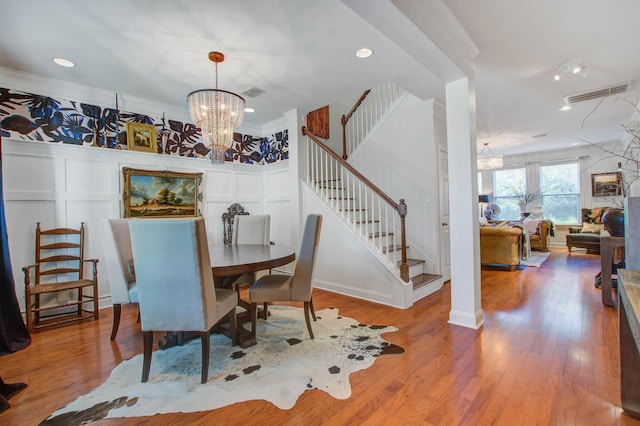 3306 Hartwell St, Johns Island, SC 29455 - dining space featuring a chandelier, stairs, recessed lighting, wood finished floors, and ornamental molding