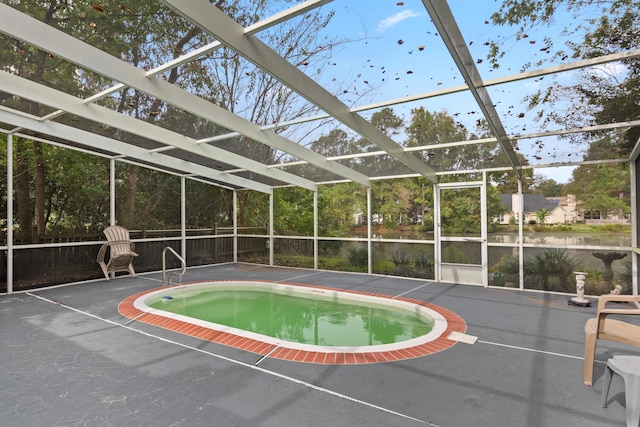 view of pool featuring glass enclosure, a patio area, and a jacuzzi