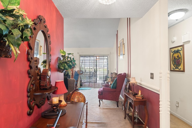 corridor featuring a textured ceiling, carpet flooring, lofted ceiling, and baseboards