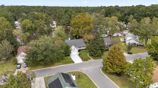 drone / aerial view with a forest view and a residential view