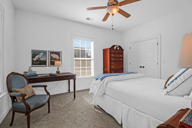 carpeted bedroom featuring ceiling fan and a closet