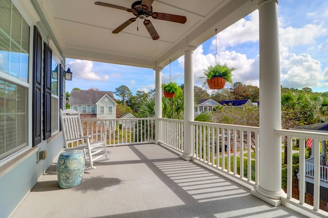 balcony featuring a porch and ceiling fan