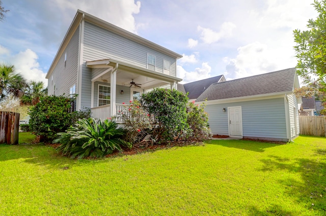 back of property with covered porch, a lawn, and ceiling fan