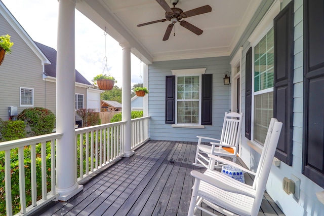 wooden deck featuring a porch and ceiling fan