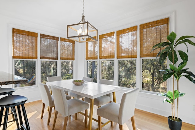 sunroom / solarium with a notable chandelier