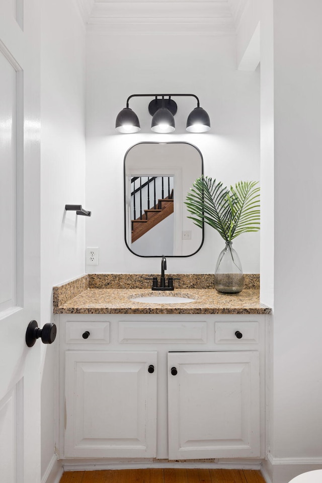 bathroom with vanity and ornamental molding