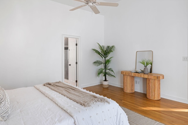 bedroom featuring a ceiling fan, wood finished floors, and baseboards