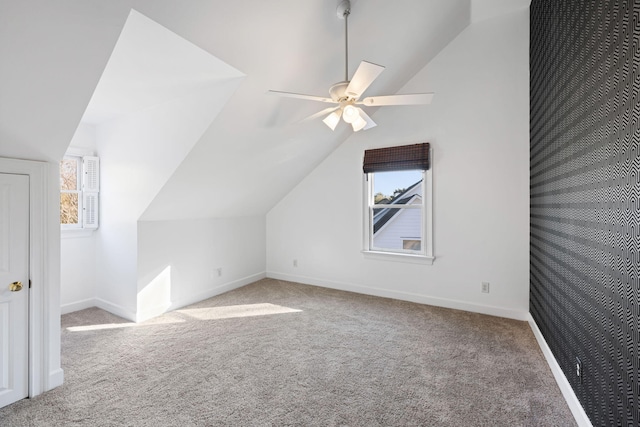 bonus room with baseboards, plenty of natural light, carpet, and lofted ceiling