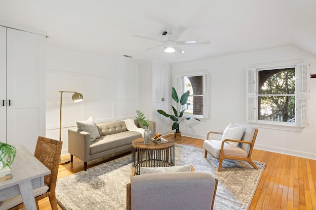 living room with baseboards, plenty of natural light, and light wood-style flooring