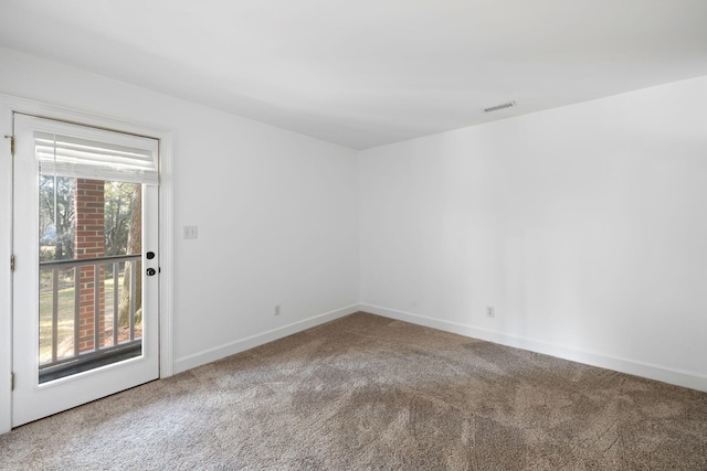 unfurnished room with carpet flooring, baseboards, and visible vents